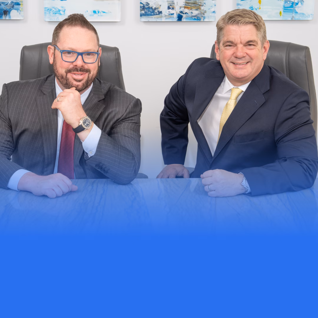 Two Grife Law Firm attorneys in business suits seated in an office