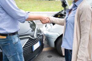 A woman and man reach an agreement following a car crash accident.