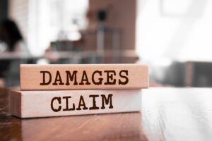 Damages & Claim Written on Wooden Blocks