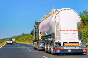 White Tanker storage truck on the asphalt highway.