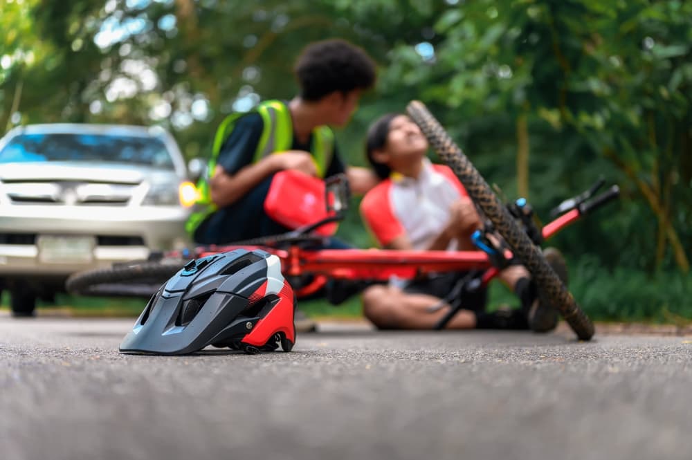 Bicycle Helmet on Street After Bike Accident Cyclist Falls, Waiting Care from First Aid in Boca Raton