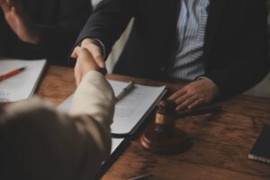 An accident victim consulting with a male lawyer during a team meeting, discussing legal services.