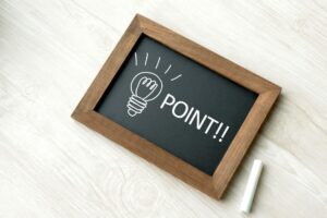 Illustration of a light bulb with a pointing message on a blackboard, symbolizing ideas or important concepts.