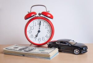 Car with money and alarm clock